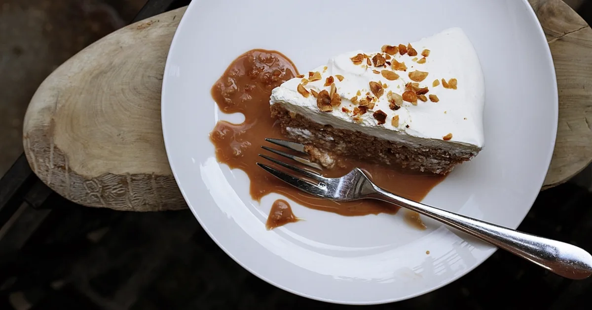 A golden caramel slice cut into squares, topped with chocolate